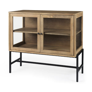 Mercana Arelius Sculptural Accent Cabinet with Glass Doors, Solid Wood & Metal Base for Modern Interiors Light Brown Wood | Black Metal 69226