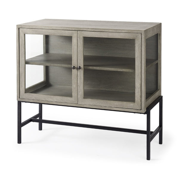 Mercana Arelius Sculptural Accent Cabinet with Glass Doors, Solid Wood & Metal Base for Modern Interiors Gray Wood | Black Metal 69291