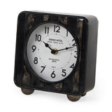 Karl 6.0L x 3.0W x 6.8H Rustic Black Iron Rounded Square Table Clock