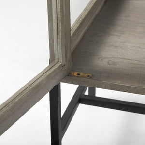 Mercana Arelius Sculptural Accent Cabinet with Glass Doors, Solid Wood & Metal Base for Modern Interiors Gray Wood | Black Metal 69291