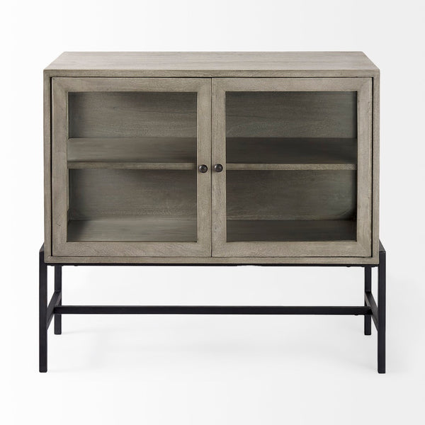 Mercana Arelius Sculptural Accent Cabinet with Glass Doors, Solid Wood & Metal Base for Modern Interiors Gray Wood | Black Metal 69291