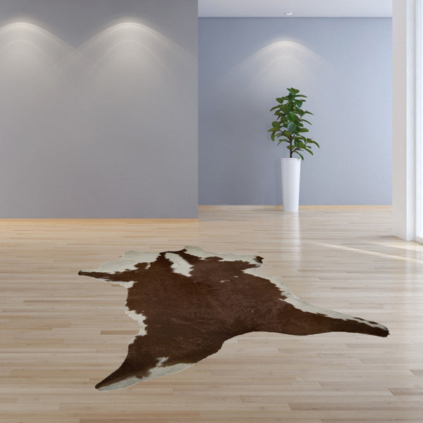 HomeRoots 2' X 3' Hand-Tufted Brown and White Cowhide Print Area Rug - Rustic Charm for Any Space! 293165