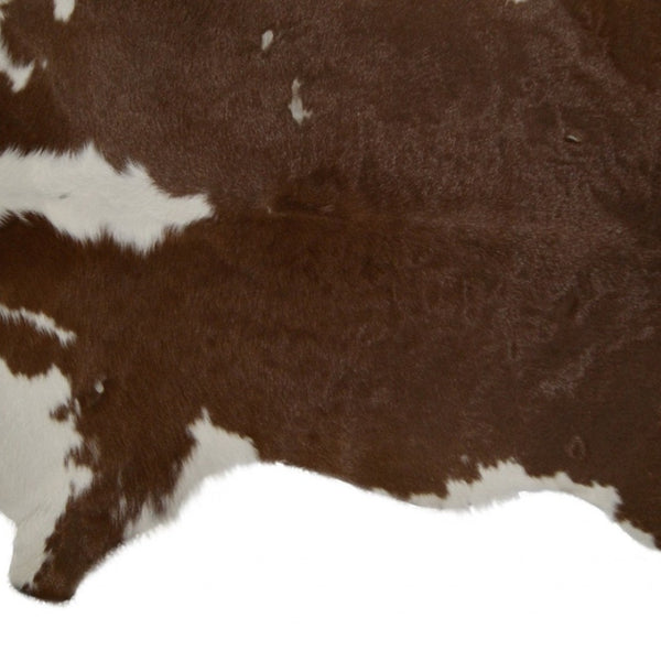 HomeRoots 2' X 3' Hand-Tufted Brown and White Cowhide Print Area Rug - Rustic Charm for Any Space! 293165