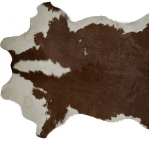 HomeRoots 2' X 3' Hand-Tufted Brown and White Cowhide Print Area Rug - Rustic Charm for Any Space! 293165