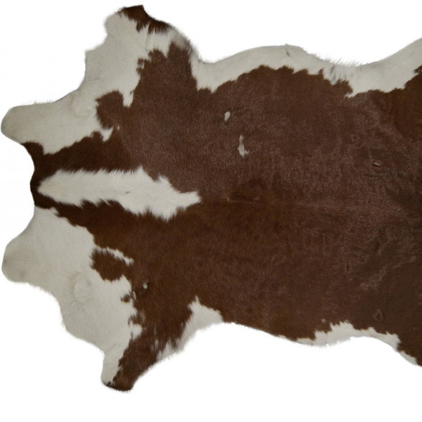 HomeRoots 2' X 3' Hand-Tufted Brown and White Cowhide Print Area Rug - Rustic Charm for Any Space! 293165