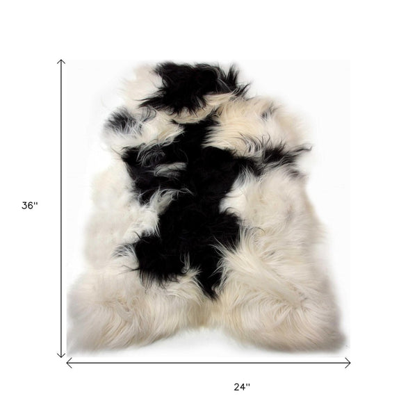 HomeRoots 2' X 3' Black and White Spotted Sheepskin Area Rug - Handmade Artisan Comfort for Cozy Spaces 316925