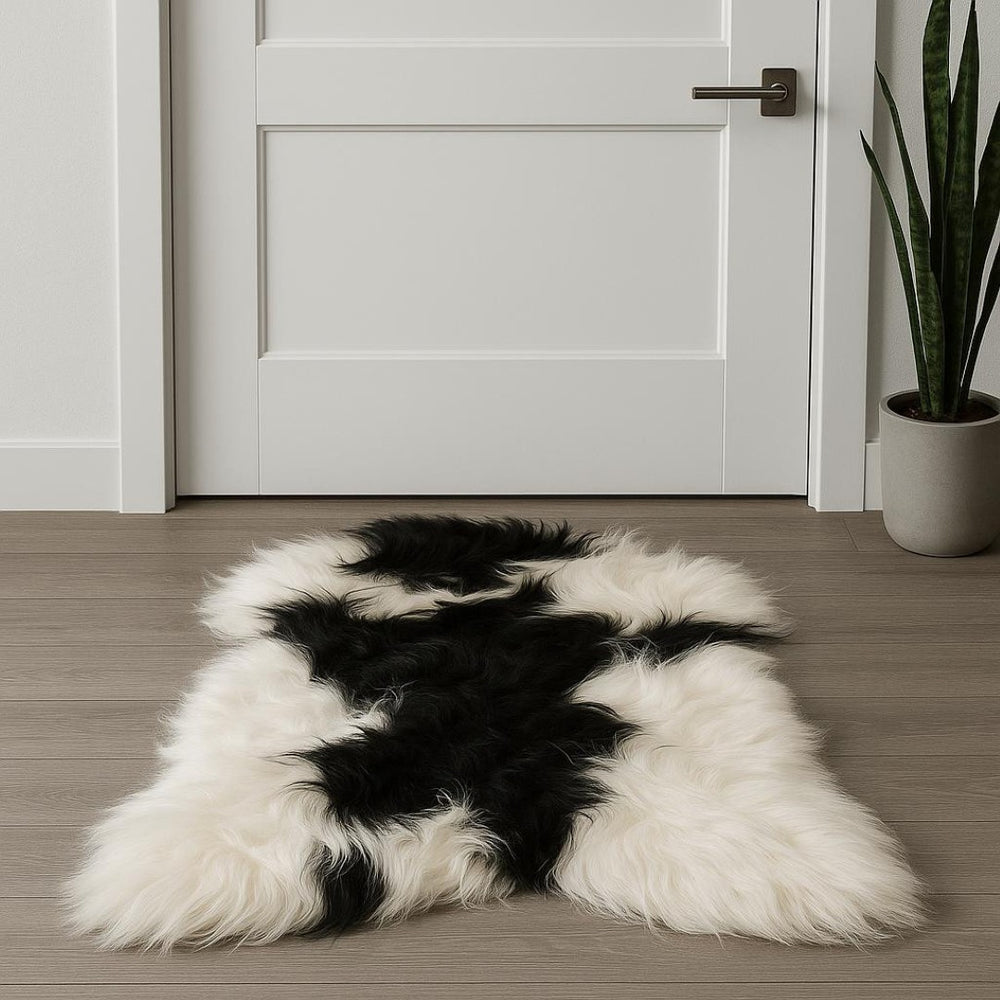 HomeRoots 2' X 3' Black and White Spotted Sheepskin Area Rug - Handmade Artisan Comfort for Cozy Spaces 316925