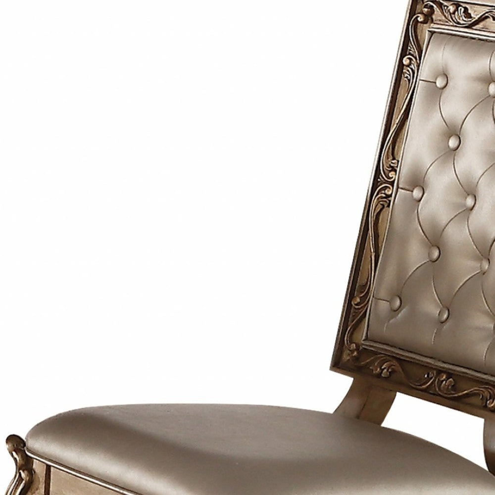 HomeRoots Set of Two Elegant Tufted Champagne Faux Leather Dining Chairs with Gold Legs & Nailhead Trim 318892