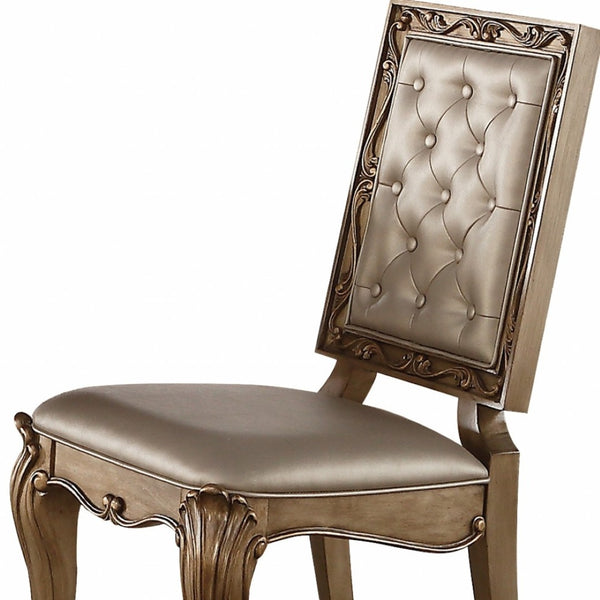 HomeRoots Set of Two Elegant Tufted Champagne Faux Leather Dining Chairs with Gold Legs & Nailhead Trim 318892