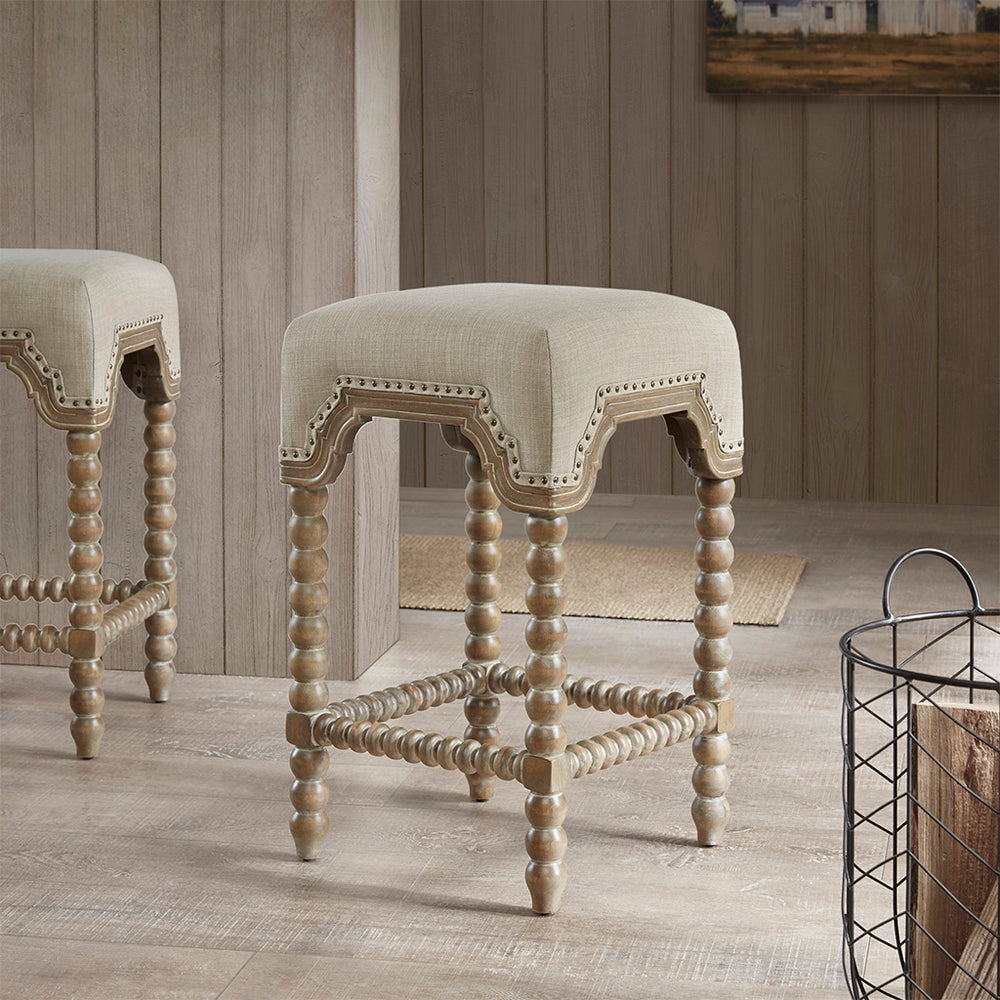 JLA Home Madison Park - Counterstool Christine Upholstered Light Grey with Bronze Nailhead Trim, Reclaimed Grey Wood Turned Legs MP104-0762