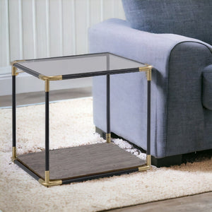 HomeRoots 24" Modern Black and Gold End Table with Clear Glass Top and Convenient Storage Shelf for Living Spaces 347391