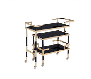 Homeroots 16" X 36" X 34" Gold Black Smoky Glass Metal Casters Serving Cart  Metal 347565
