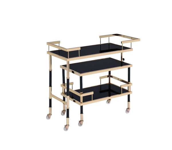 Homeroots 16" X 36" X 34" Gold Black Smoky Glass Metal Casters Serving Cart  Metal 347565