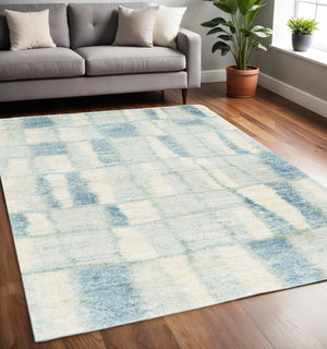HomeRoots 5' Ivory and Blue Abstract Area Rug - Contemporary Artistry, Durable Performance for Any Space 5" x 8" 352490