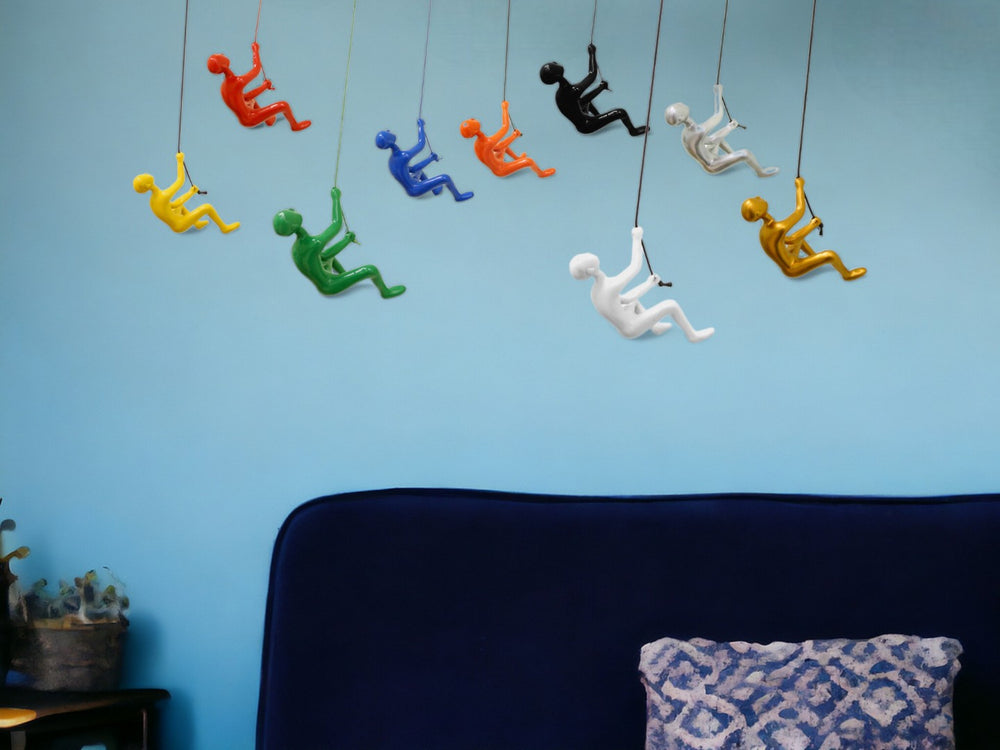 HomeRoots Set of Nine Colorful Resin Climbing Man Sculptures - Whimsical 3D Wall Art for Any Room Decor 358143