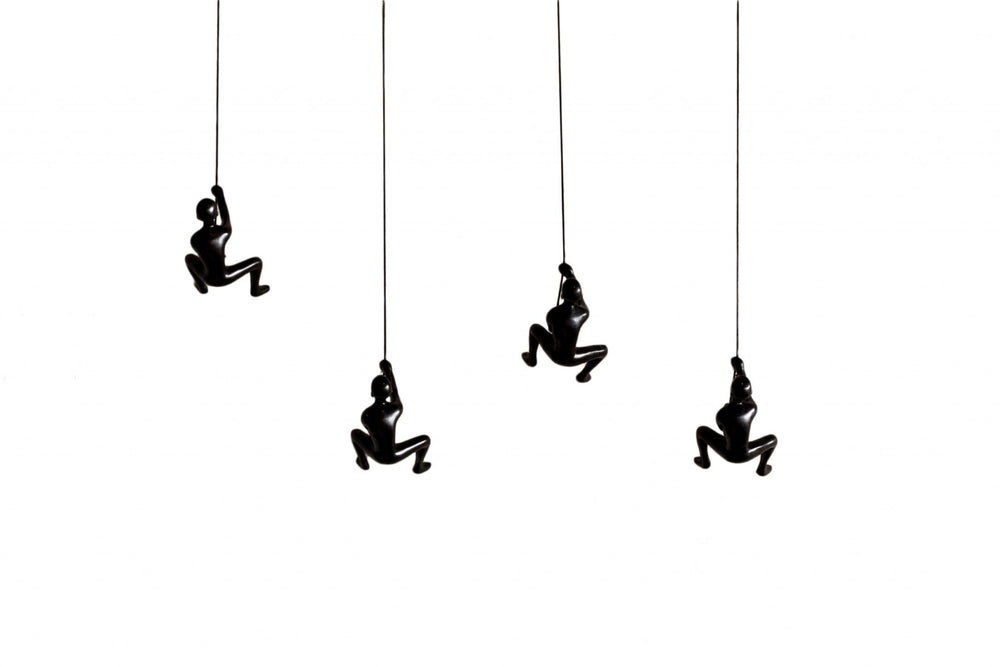 HomeRoots Set of Four Black Resin Climbing Men Sculptures - Dynamic Wall Art for Modern Living Spaces 358145