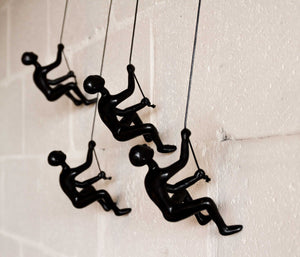 HomeRoots Set of Four Black Resin Climbing Men Sculptures - Dynamic Wall Art for Modern Living Spaces 358145