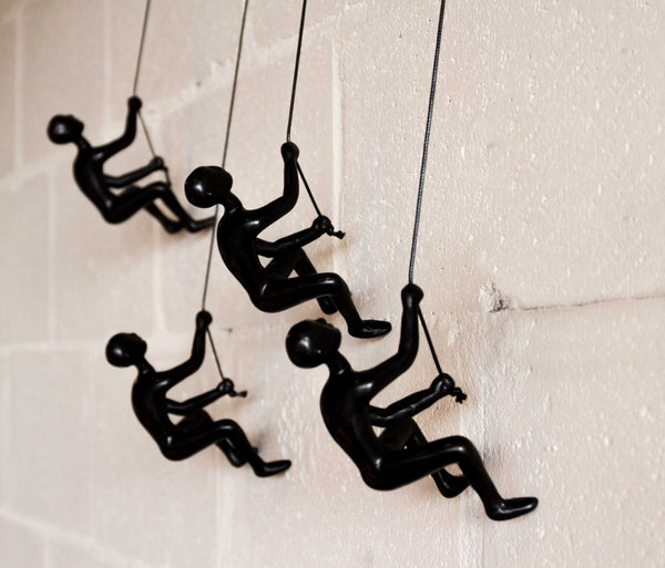 HomeRoots Set of Four Black Resin Climbing Men Sculptures - Dynamic Wall Art for Modern Living Spaces 358145