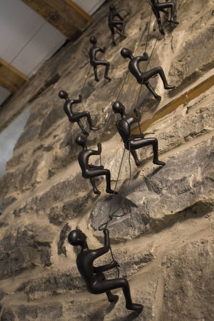 HomeRoots Set of Four Black Resin Climbing Men Sculptures - Dynamic Wall Art for Modern Living Spaces 358145