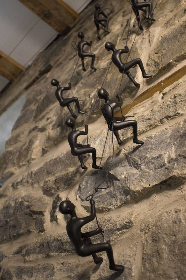 HomeRoots Set of Four Black Resin Climbing Men Sculptures - Dynamic Wall Art for Modern Living Spaces 358145