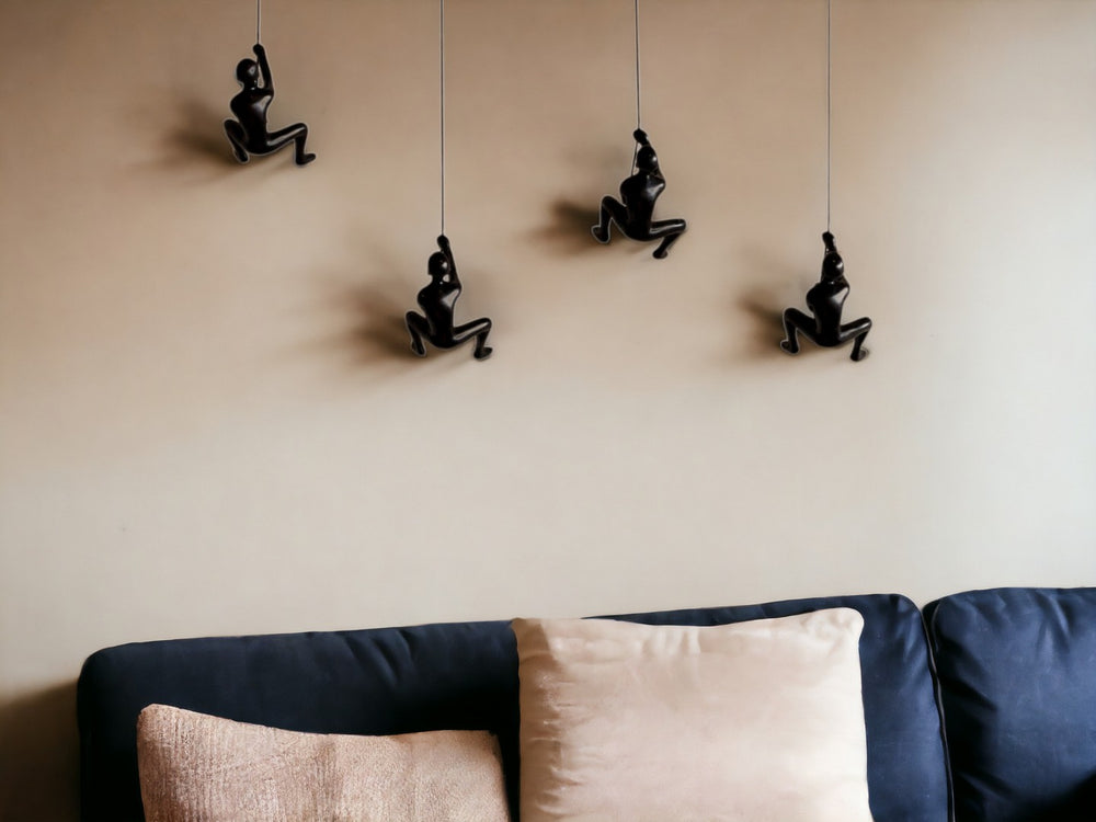 HomeRoots Set of Four Black Resin Climbing Men Sculptures - Dynamic Wall Art for Modern Living Spaces 358145