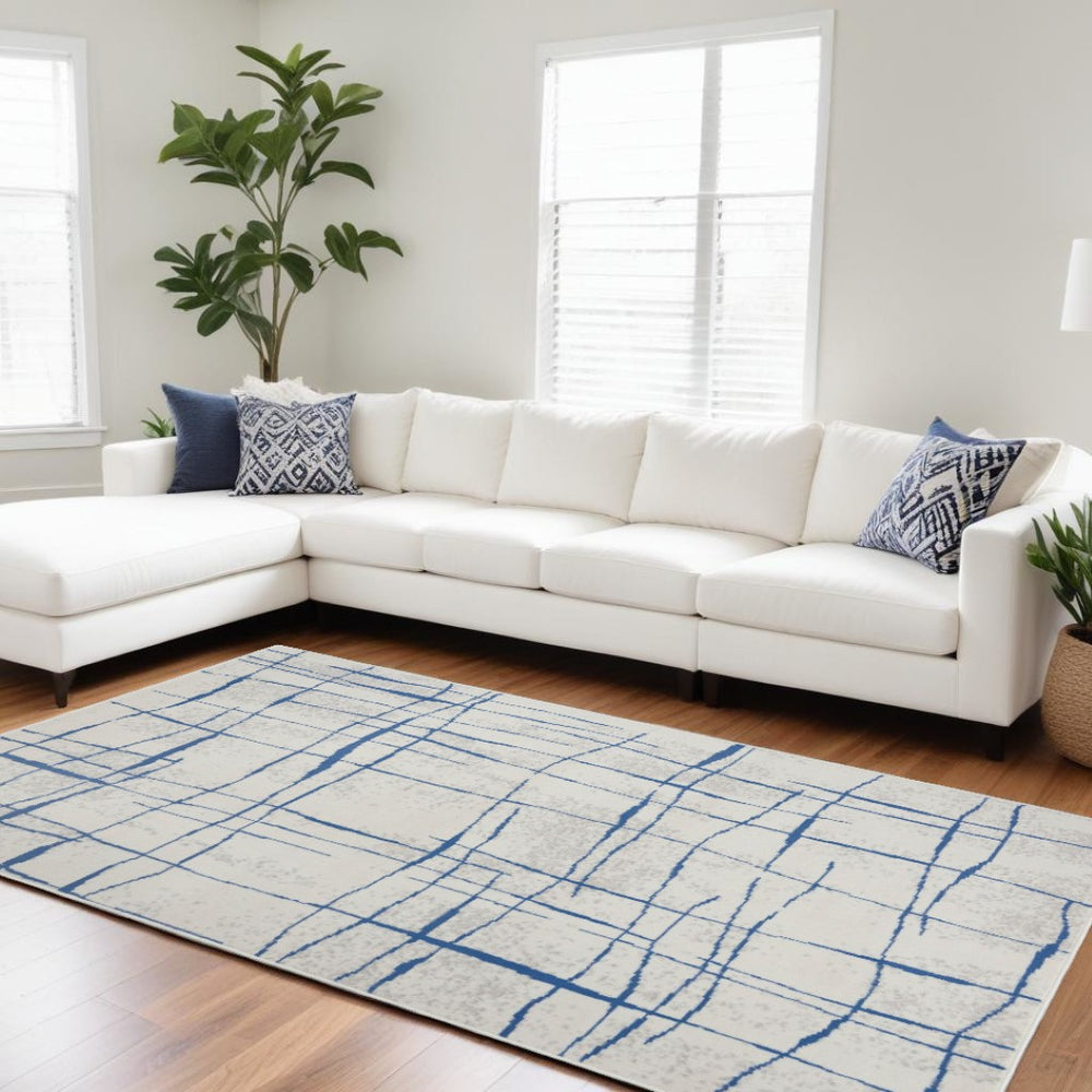 HomeRoots 6' Modern Ivory and Blue Geometric Distressed Area Rug for Stylish Living Spaces and Warmth 6?x9? 385864