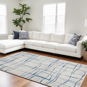 HomeRoots 6' Modern Ivory and Blue Geometric Distressed Area Rug for Stylish Living Spaces and Warmth 6?x9? 385864