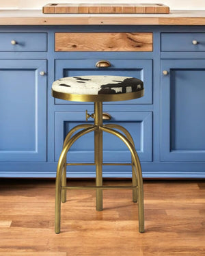 HomeRoots Black Adjustable Height Swivel Bar Chair in Hair-on-Hide with Gold Iron Base for Modern Spaces 389122