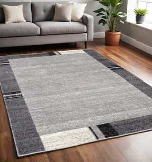 HomeRoots 4' Modern Bordered Area Rug - Elegant Dove-Gray Design for Comfort in Living, Dining, or Bedroom Spaces 5x8 390368