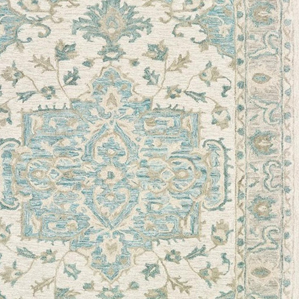 HomeRoots 5' Turquoise and Cream Medallion Area Rug - Plush, Hand-Tufted Wool Blend for Timeless Elegance 5' X 8' 395917