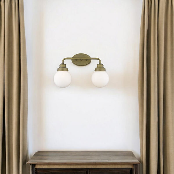 HomeRoots Two Light Gold Wall Sconce with Clear Round Glass Shades for Modern Hallways and Living Spaces 398702