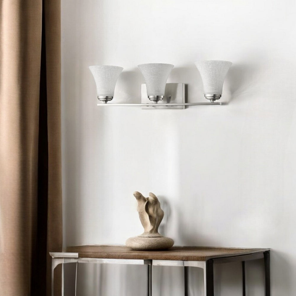 HomeRoots Three Light Silver Wall Fixture with Textured Tapered Glass Shades for Modern Ambient Lighting 398752