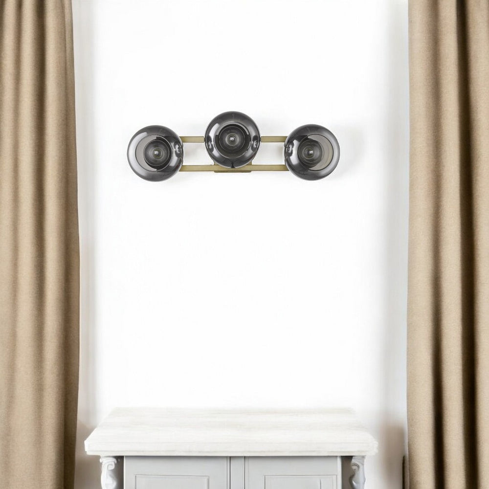 HomeRoots Lunette 3-Light Aged Brass Sconce - Mid-Century Modern Elegance with Smoked Glass for Ambient Spaces 398792