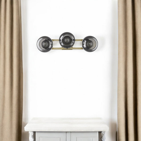HomeRoots Lunette 3-Light Aged Brass Sconce - Mid-Century Modern Elegance with Smoked Glass for Ambient Spaces 398792