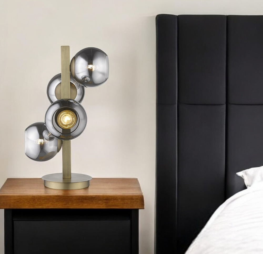 Homeroots 24" Brass Metal Four Light Novelty Table Lamp With Silver Metallic Globe Shades   399145