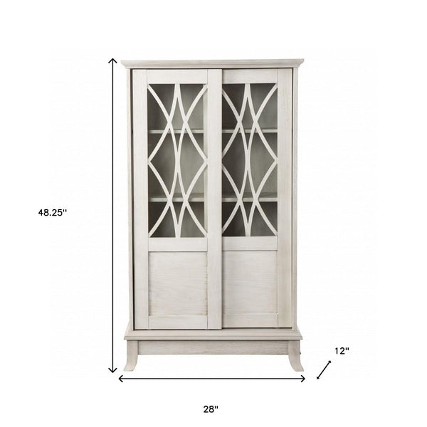 HomeRoots 28" Elegant White Accent Cabinet with Eight Shelves, Lattice Scrollwork, and Sliding Doors for Storage 401697