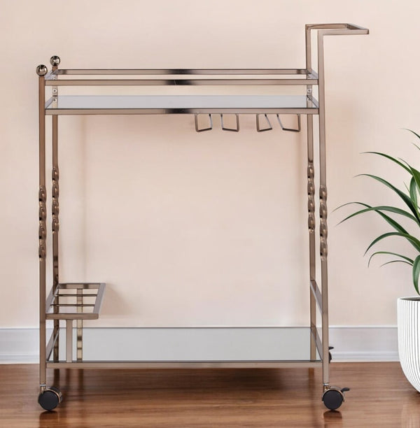 HomeRoots Champagne Metal Rolling Bar Cart with Mirrored Glass Top, Wine Storage & Smooth Mobility Features 402581