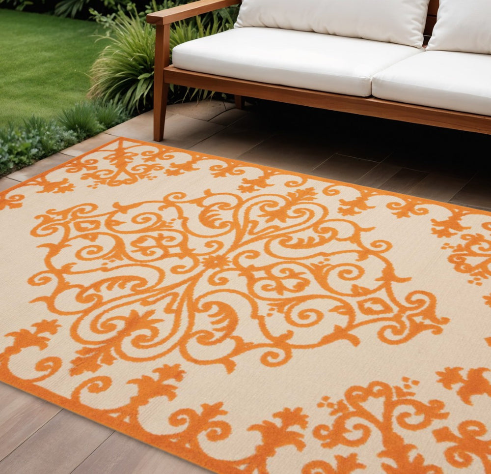 HomeRoots 10' Orange and Ivory Area Rug - Stylish Indoor/Outdoor Damask Design, Durable, Easy-Care, Versatile! 479300