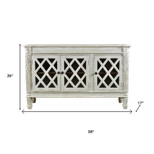 HomeRoots 58" Elegant White Distressed Solid Wood Sideboard with Glass Doors & Carved Scrollwork for Storage 488487