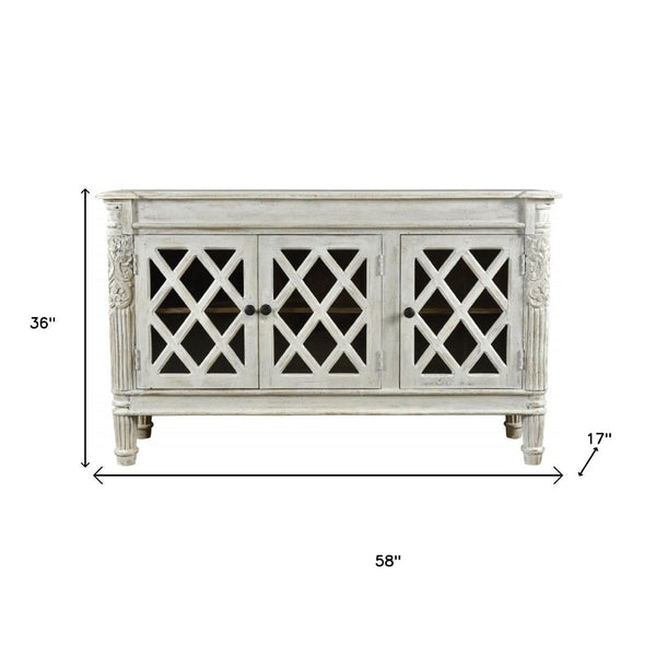HomeRoots 58" Elegant White Distressed Solid Wood Sideboard with Glass Doors & Carved Scrollwork for Storage 488487
