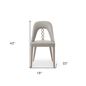 HomeRoots Set of Two Light Gray Faux Leather Dining Chairs with Chic Rose Gold Accents for Modern Spaces 488512