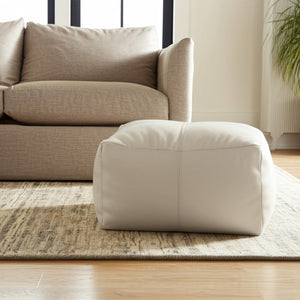 HomeRoots 22" Ivory Leather Pouf Ottoman - Chic Multi-Purpose Footrest & Stylish Extra Seating for Any Space 488747