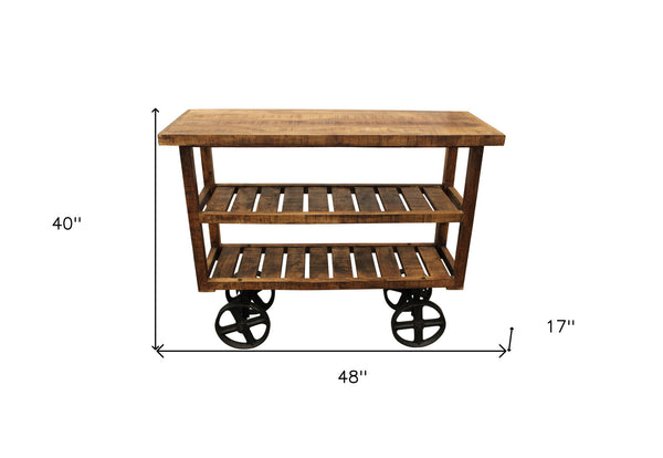 Homeroots 48" Brown And Black Solid Wood Distressed Wheel Console Table With Storage   488851