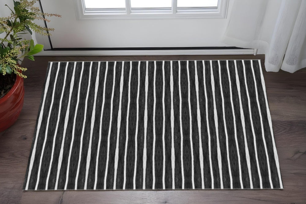 HomeRoots 2' X 5' Black And White Striped Vinyl Area Rug - UV Protected, Water-Resistant, Non-Slip Design! 489511