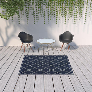 HomeRoots 5' Indoor Outdoor Geometric Area Rug - Stain Resistant Blue and Ivory Design for Versatile Spaces Navy/ Ivory 5'3" x 7'6" 507071