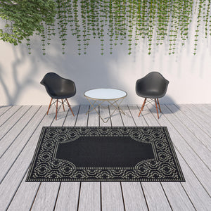 Homeroots 7' X 10' Black And Ivory Stain Resistant Indoor Outdoor Area Rug Black,Ivory Polypropylene 507681