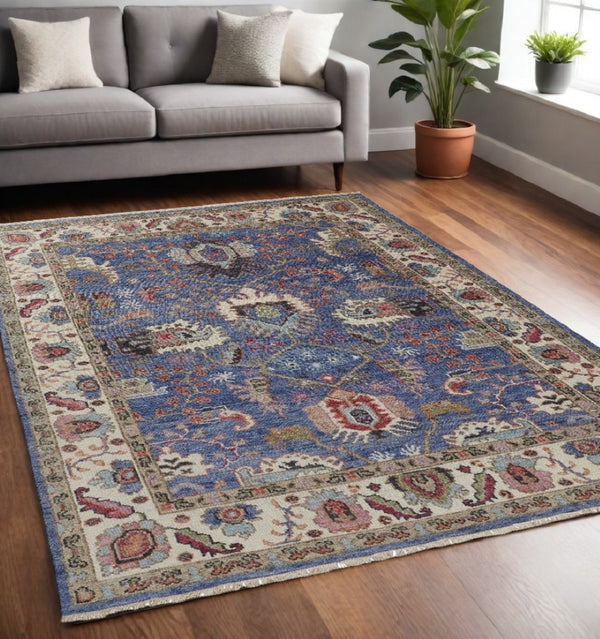 HomeRoots 4' Hand-Knotted Wool Area Rug with Blue and Red Floral Design - Durable, Stain-Resistant Beauty 5' X 8' 513087