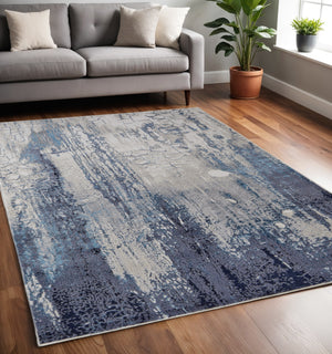 Homeroots 5' X 8' Ivory And Blue Abstract Power Loom Distressed Non Skid Area Rug  Polyester 513935