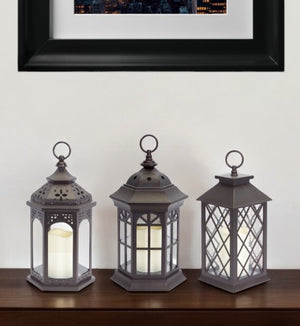 HomeRoots Set of Three Dark Brown Distressed Lantern Candle Holders with Ornate Design – Perfect for Any Space! 517555
