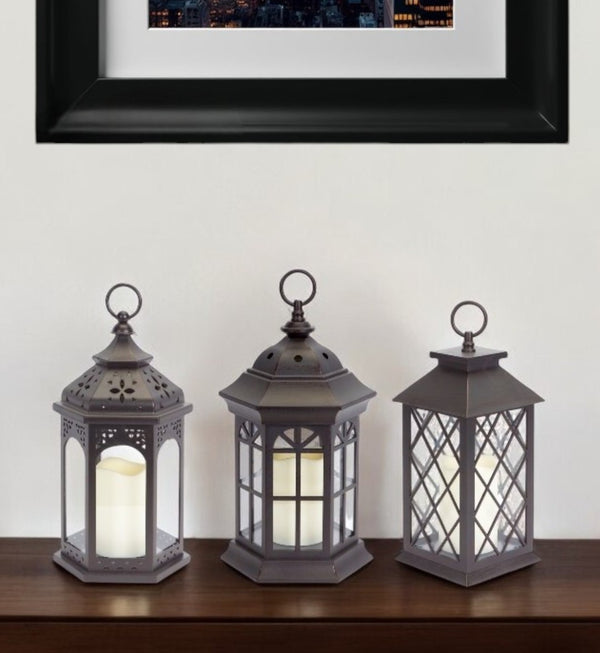 HomeRoots Set of Three Dark Brown Distressed Lantern Candle Holders with Ornate Design – Perfect for Any Space! 517555